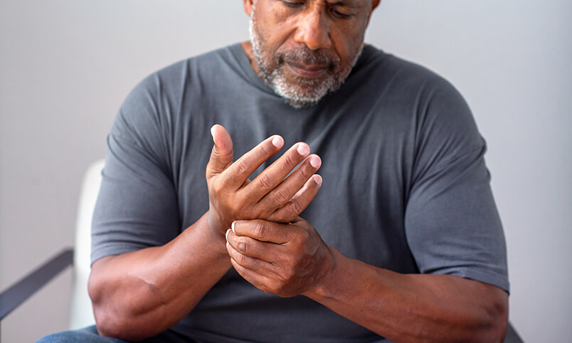man with arthritis pain in hand and wrist