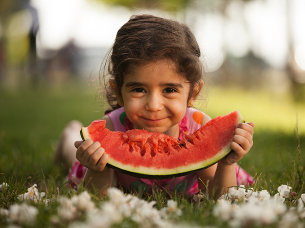 Girl enjoying summer watermelon - Summer Is Time for Kids to Try New Foods